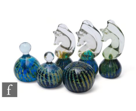 A collection of Mdina glass paperweights, three of seahorse form, another of globe form and two others of globe form with upp