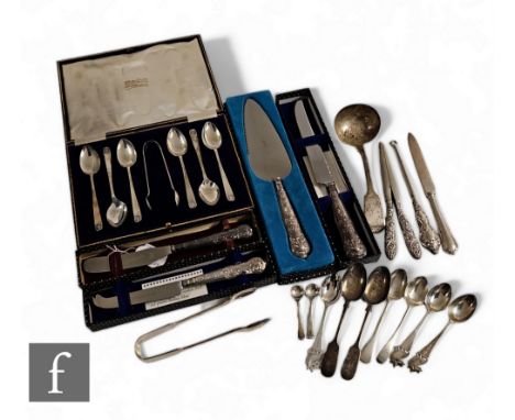 A small parcel lot of assorted hallmarked silver flatware to include teaspoons, a ladle, tongs and four boxed silver handled 