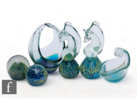 A collection of Mdina glass, comprising two paperweights formed as seahorses, two of small globe form, a small high sided dis