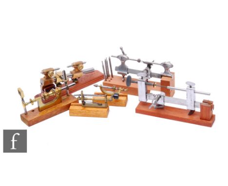 Six early 20th Century watch maker's lathes and tools, each on a mahogany plinth base. (6) 