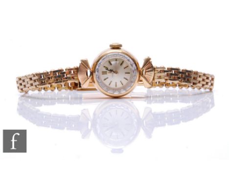 A lady's 9ct Omega manual wind wrist watch, batons to a circular silvered dial, all to a 9ct gate link bracelet, total weight