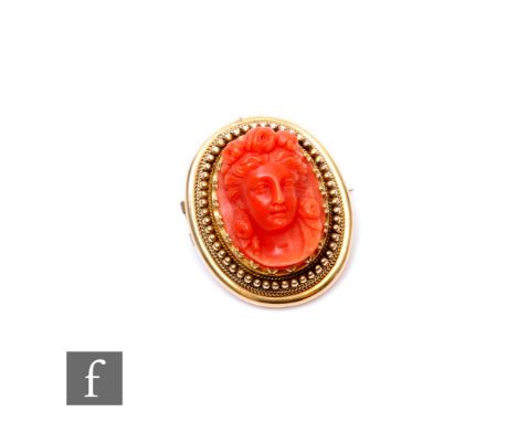 A 19th Century 15ct carved coral cameo portrait of a classical woman within a beaded and rope twist border, weight 5g, length