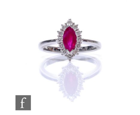 An 18ct hallmarked white gold ruby and diamond cluster ring, central marquise ruby within a twelve diamond surround, weight 3