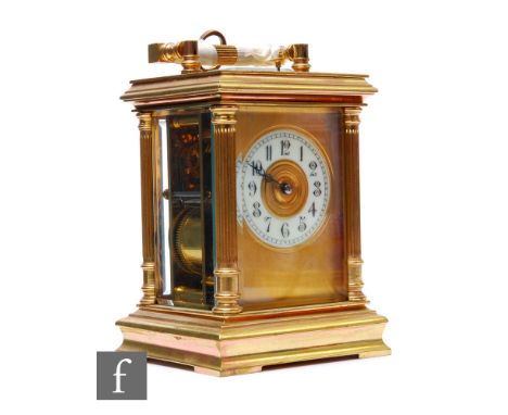 An early 20th Century brass carriage clock, circular Arabic dial in Corinthian column stepped case with push button repeat, w