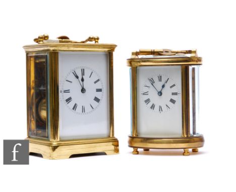 An early 20th Century French brass carriage clock with enamelled dial, height 13cm, and a similar oval carriage clock, both w