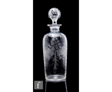 An early 20th Century Stourbridge clear crystal decanter of shouldered ovoid from, the body decorated with engraved floral sw