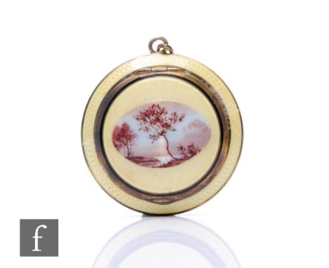 An early 20th Century French silver gilt compact pendant with central oval lake land scene within yellow enamelled decorated 