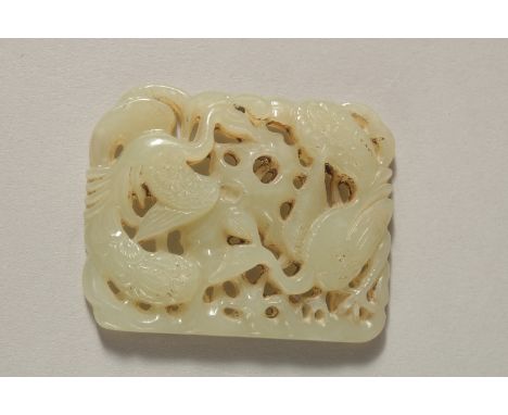 A VERY FINE 19TH CENTURY OR EARLIER CHINESE CARVED JADE PLAQUE, depicting two peacocks, 5.5cm x 4.5cm.