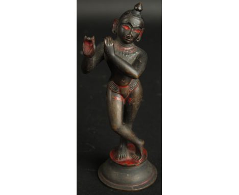 A FINE 18TH CENTURY INDIAN BENGHAL BRONZE FIGURE OF FLUTING KRISHNA, with traces of black and red pigment, 17cm high.