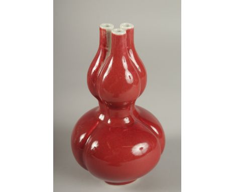 A CHINESE IRON RED GLAZE TULIP VASE, the base with character mark, 20cm high.