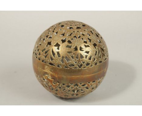 A FINE EARLY 19TH CENTURY MUGHAL NORTH INDIAN OPENWORKED BRASS HAND WARMER, with birds and flower designs, 10cm diameter.