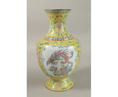 A CHINESE YELLOW GROUND ENAMELLED VASE, painted with a panel depicting an exotic bird and flora, further decorated with flora