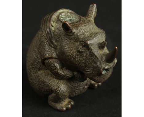 A BRONZE OKIMONO OF A RHINOCEROS.