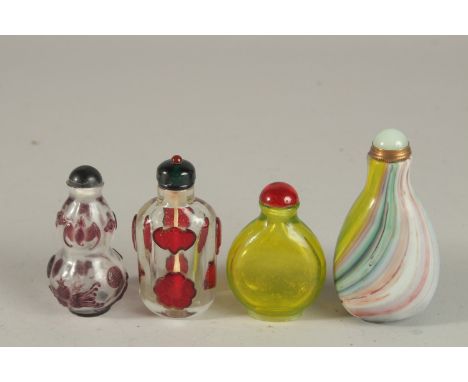 A COLLECTION OF FOUR CHINESE PEKING GLASS SNUFF BOTTLES AND STOPPERS, (4).