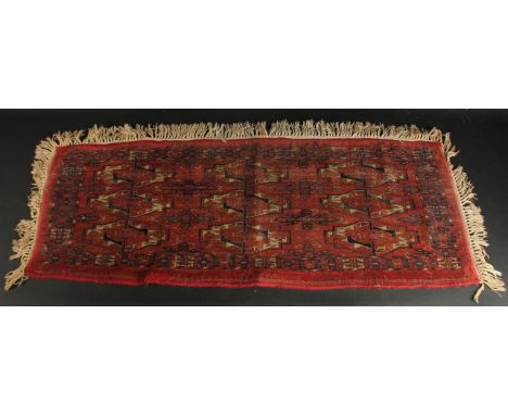 A LATE 19TH CENTURY TEKKE RUG, 120cm x 46cm (excl. tassles).