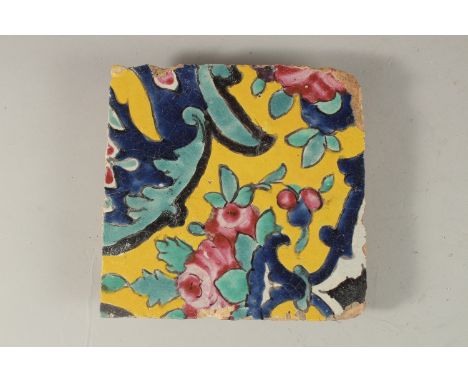 AN EARLY 19TH CENTURY PERSIAN YELLOW GLAZED POTTERY TILE, 18cm x 18cm.