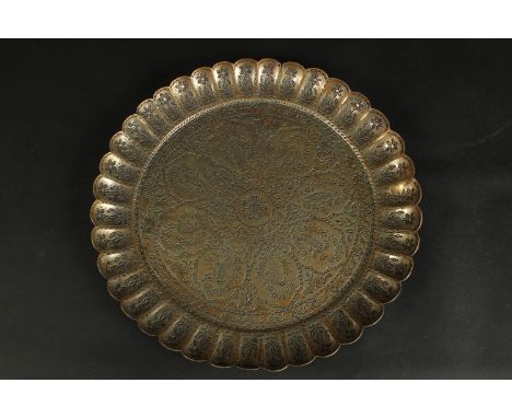 A FINE 18TH CENTURY MUGHAL INDIAN TINNED BRASS CHARGER, signed to the reverse, 34cm wide.