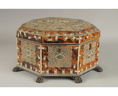 A 19TH CENTURY ANGLO INDIAN TORTOISESHELL, BONE AND PENWORK OCTAGONAL SEWING BOX, 33cm at widest point.