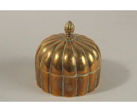 A 19TH CENTURY MUGHAL INDIAN DOMED BRASS PANDAN BOX, 12cm high.