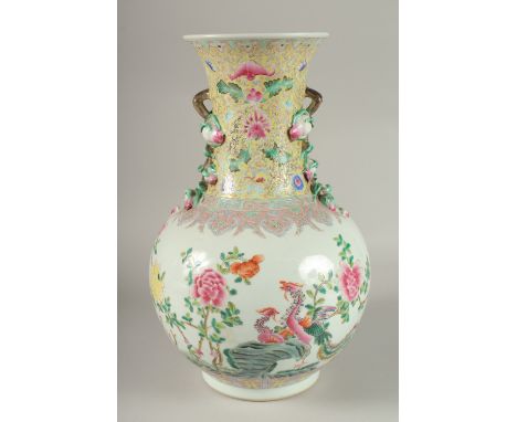 A LARGE CHINESE FAMILLE ROSE PORCELAIN VASE, painted with exotic birds and flora, with moulded fruiting blossom handles, the 