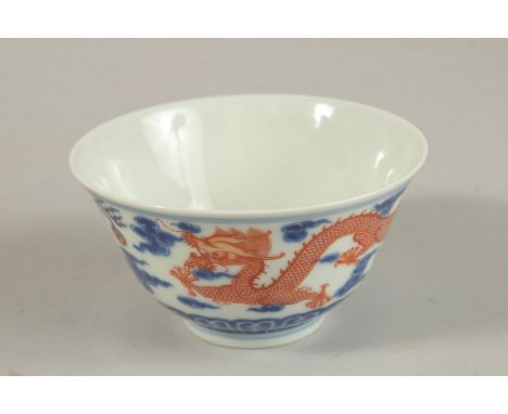 A CHINESE BLUE AND WHITE WITH COPPER RED DRAGON TEA BOWL, six-character mark to base, 11cm diameter.