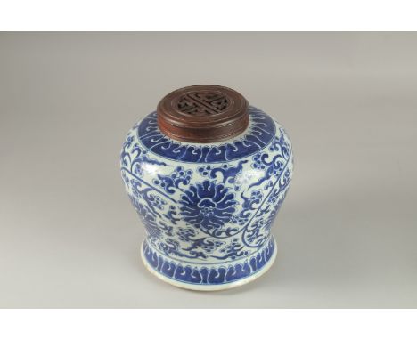 A CHINESE BLUE AND WHITE PORCELAIN JAR AND HARDWOOD COVER, 23cm high.