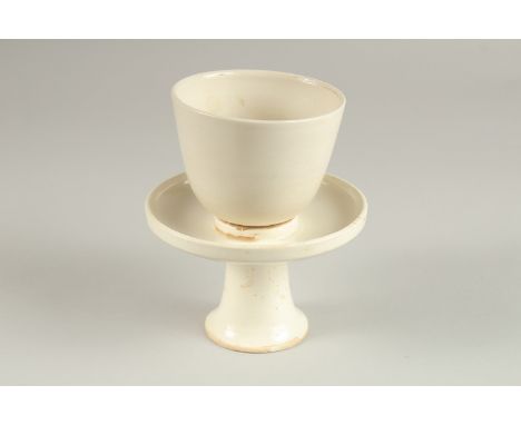 A CHINESE DING WARE CUP AND PEDESTAL SAUCER DISH.