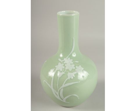 A CHINESE CELADON GLAZE PORCELAIN FLORAL BOTTLE VASE, the base with character mark, 26cm high.