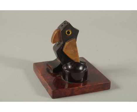 AN EARLY 20TH CENTURY ART DECO DUNHILL STYLE BIRD-SHAPED MATCH HOLDER, with bakelite or cherry amber ashtray, base 11cm x 9.5