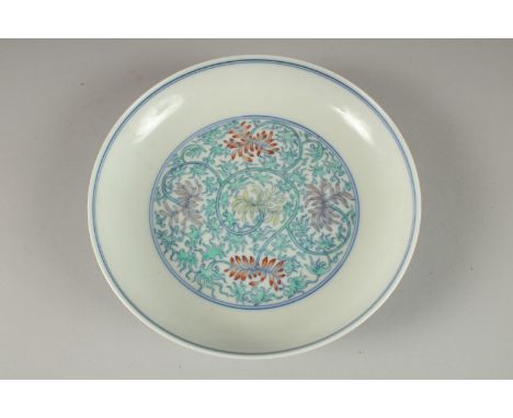 A CHINESE POLYCHROME PORCELAIN FLORAL DISH, the base with six- character mark, 16cm diameter.