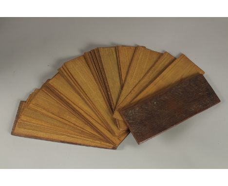 A VERT FINE 19TH CENTURY OR EARLIER INDIAN PRAYER BOOK, comprising a large number of etched palm leaves, 24.5cm long.