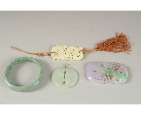 THREE CARVED JADE PENDANTS, one with gold clasp, together with a green hardstone bangle, (4).