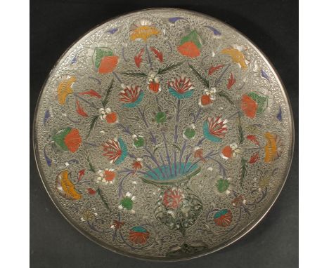 AN INDIAN ENGRAVED AND ENAMELLED WHITE METAL FLORAL DISH, 29cm diameter.