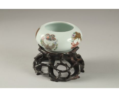 A CHINESE PORCELAIN BOWL ON A CARVED HARDWOOD STAND, the bowl painted with butterflies and bearing six character mark to base