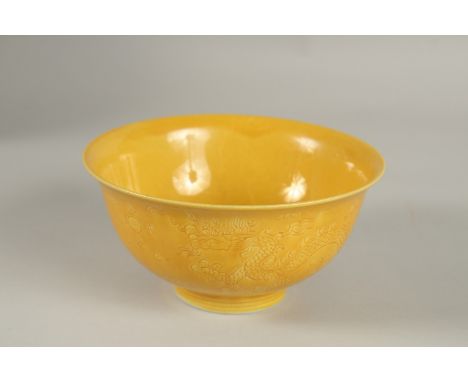 A CHINESE YELLOW GLAZE PORCELAIN BOWL, with incised decoration, base with character mark, 15cm diameter.