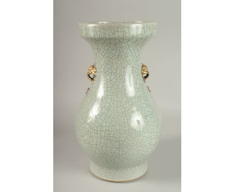 A LARGE CHINESE CELADON CRACKLE GLAZE PORCELAIN VASE, with gilded win handles, 39cm high. Povenance: Bonhams 09.05.22 auction