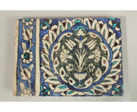 A FINE LARGE 17TH CENTURY OTTOMAN DAMASCUS GLAZED POTTERY TILE, with central floral panel, 27.5cm x 20cm.