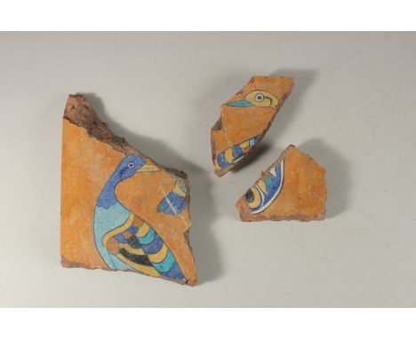 THREE 17TH-18TH INDIAN TILE FRAGMENTS, with bird designs, largest 29cm wide, (3).