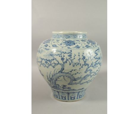 A LARGE CHINESE BLUE AND WHITE PORCELAIN JARDINIERE, painted with trees and clouds, 34cm high.