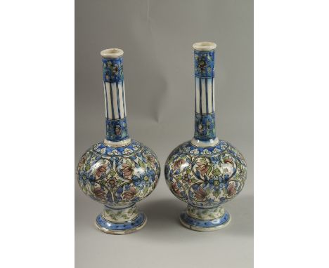 A FINE PAIR OF 19TH CENTURY PERSIAN QAJAR GLAZED POTTERY BOTTLE VASES, 32cm high.