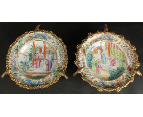 A FINE PAIR OF CHINESE CANTON FAMILLE ROSE PORCELAIN PLATES with gilded metal foliate mounts with bird finials, each plate pa