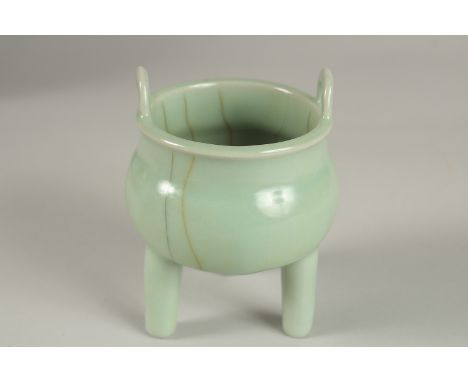 A CHINESE CELADON GLAZE PORCELAIN TRIPOD CENSER, 13cm high.