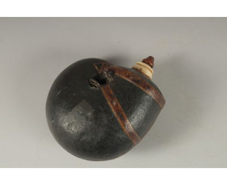 A FINE 18TH-19TH CENTURY MUGHAL INDIAN LEATHER MOUNTED POWDER FLASK, 16cm high.