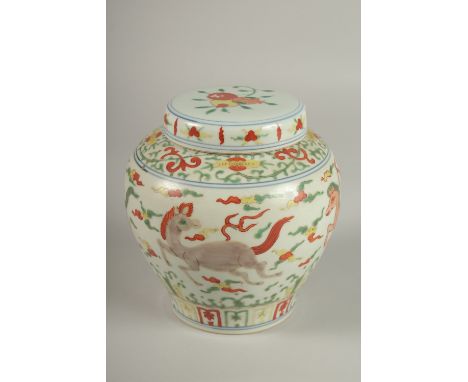 A CHINESE DOUCAI PORCELAIN JAR AND COVER, painted with horses, 16cm high.