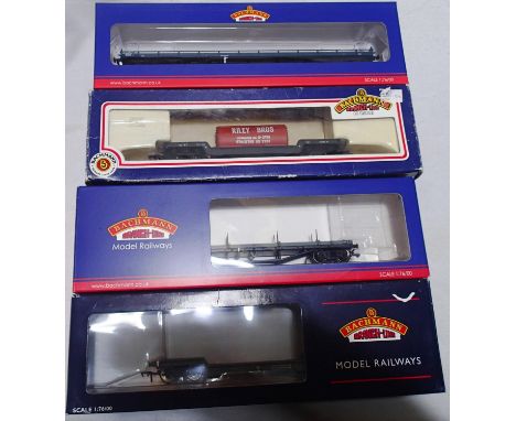 Four Bachmann OO scale Bogie wagons to include 38901 Car flat BR Blue, 33856C Bogie BR Grey, 33901C Bogie well BR Grey and 33