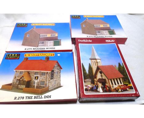 Four OO scale plastic kits to include two Hornby R275 modern houses, Hornby R278 The Bell Inn and Pola HO605 Dorfkirche, most