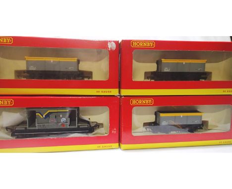 Four OO scale Hornby wagons to include three R6107A ore wagons and a R6500 20 ton brake van, all in excellent condition, wear