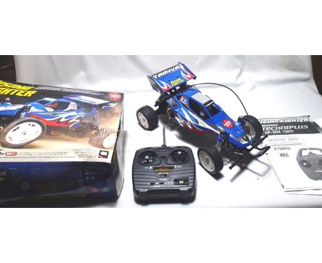 Tamiya 1/10 scale Rising Fighter radio controlled buggy with Acoms transmitter, appears in very good condition, missing one w