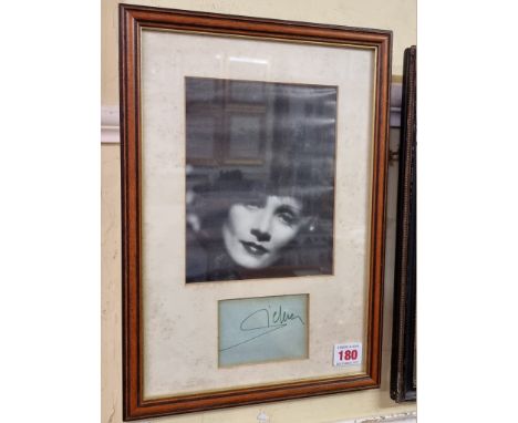 MARLENE DIETRICH:&nbsp;autograph of Dietrich in green ink on blue paper, mounted below black and white photographic portrait,