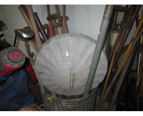 Galvanized dustbin of assorted garden tools